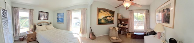 carpeted bedroom with ceiling fan and lofted ceiling