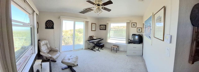 carpeted office featuring ceiling fan