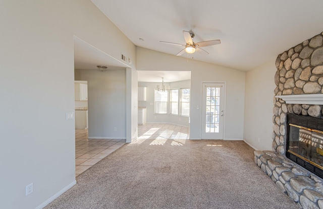 carpeted living room featuring ceiling fan with notable chandelier, lofted ceiling, and a fireplace