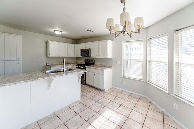 kitchen with pendant lighting, white cabinets, stainless steel appliances, and sink