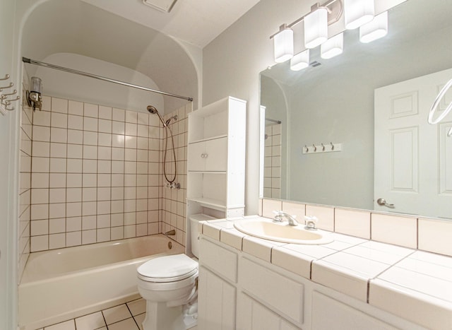 full bathroom with tile patterned floors, vanity, toilet, and tiled shower / bath