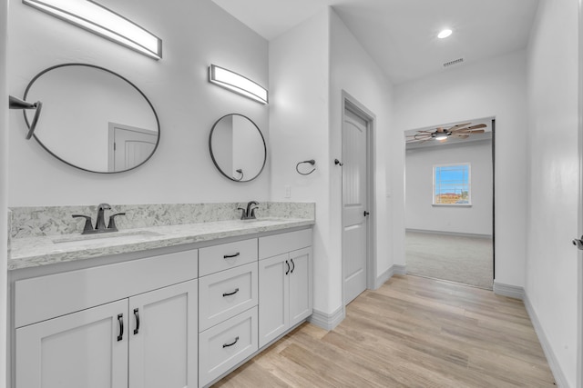 bathroom with hardwood / wood-style floors, vanity, and ceiling fan