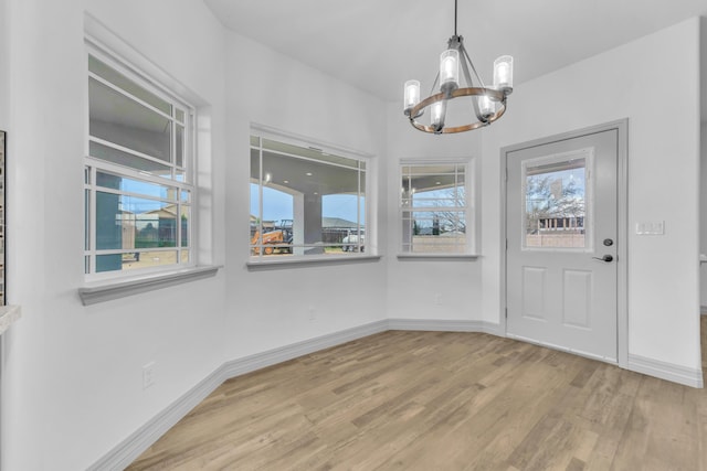 interior space with light hardwood / wood-style flooring and a chandelier