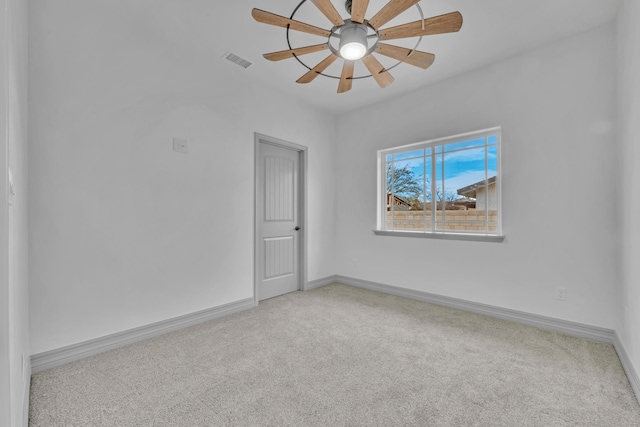 carpeted empty room featuring ceiling fan