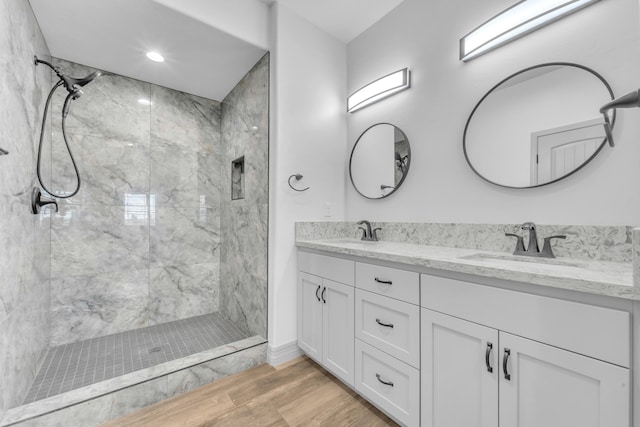 bathroom with vanity and tiled shower