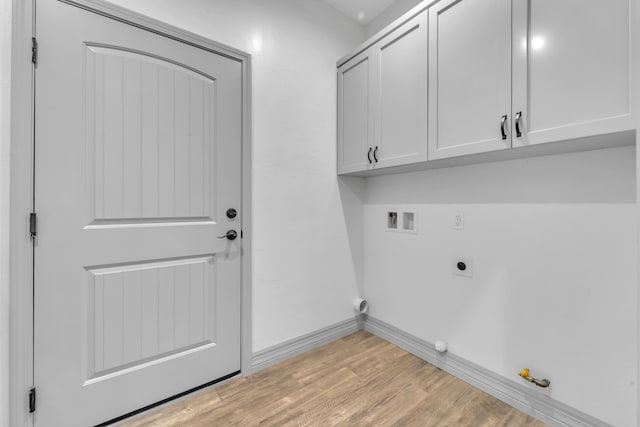 clothes washing area featuring gas dryer hookup, cabinets, hookup for a washing machine, light hardwood / wood-style flooring, and hookup for an electric dryer