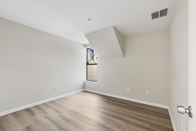 spare room with hardwood / wood-style floors