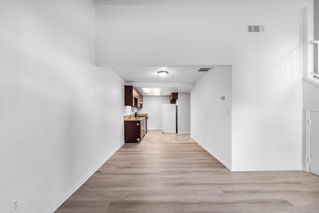 corridor with light wood-type flooring