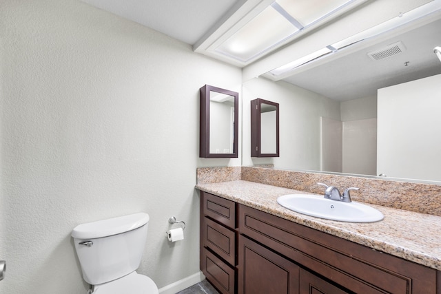 bathroom with a shower, vanity, and toilet