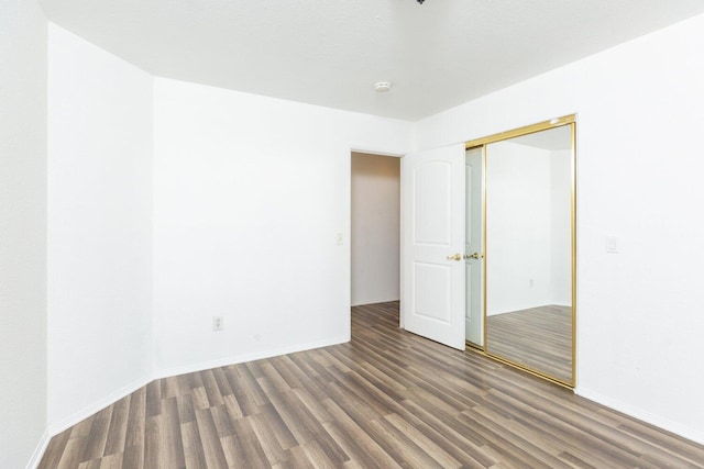 spare room with dark hardwood / wood-style flooring