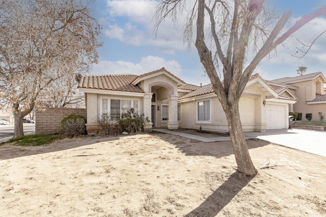 mediterranean / spanish-style home with a garage