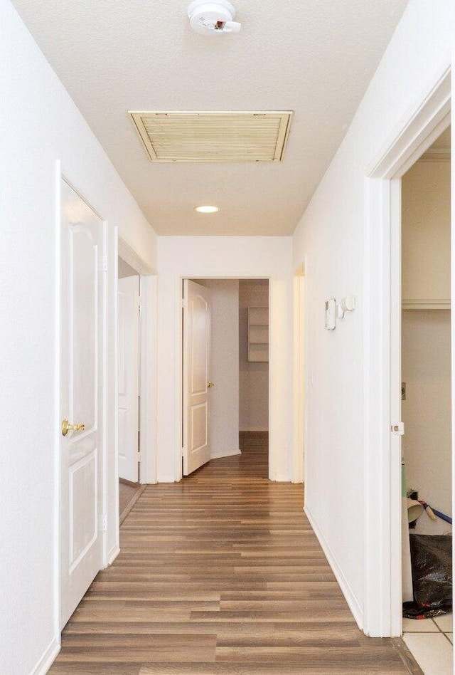 hallway with hardwood / wood-style floors