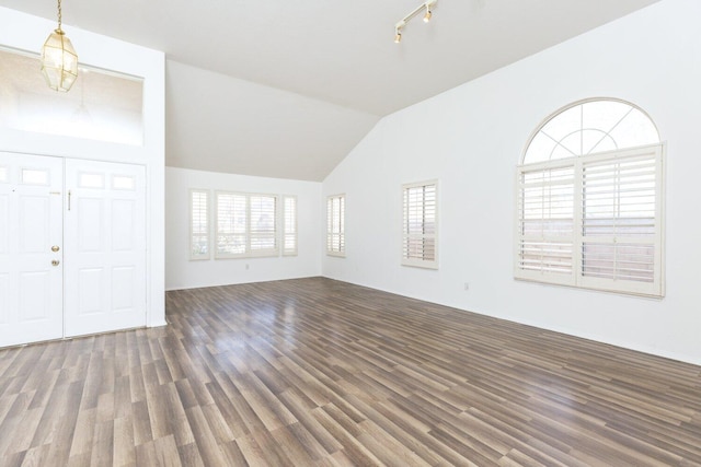 unfurnished living room with dark hardwood / wood-style flooring and vaulted ceiling