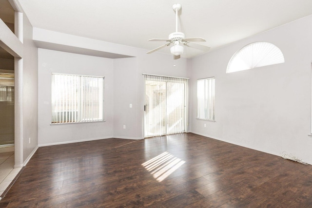 spare room featuring dark hardwood / wood-style flooring and ceiling fan