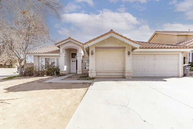 mediterranean / spanish home with a garage