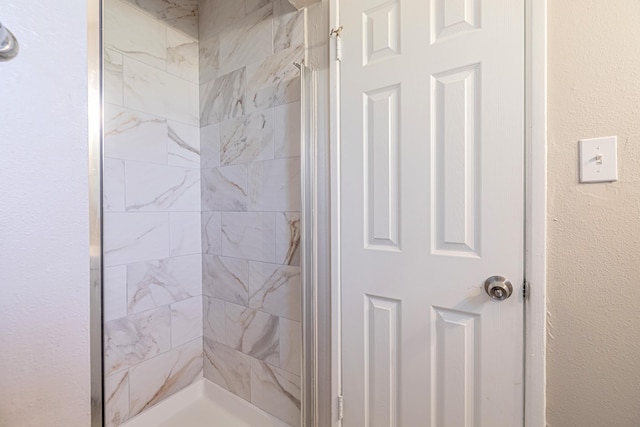 bathroom with tiled shower