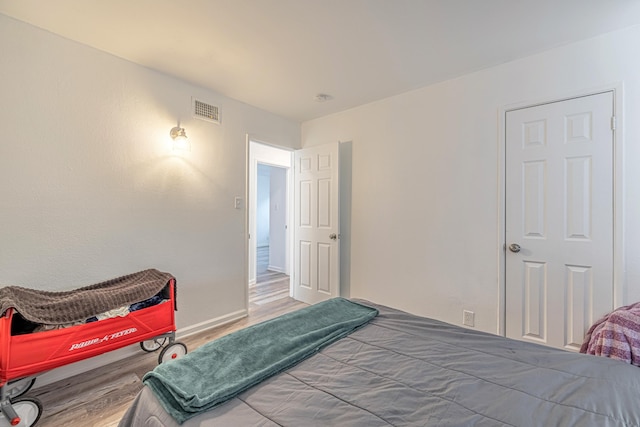 bedroom with hardwood / wood-style flooring