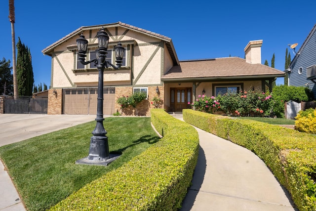 view of front of house with a front yard and a garage