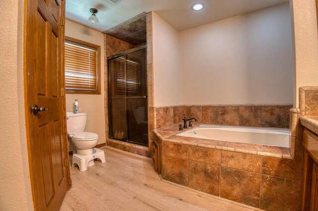 bathroom featuring plus walk in shower, wood-type flooring, and toilet