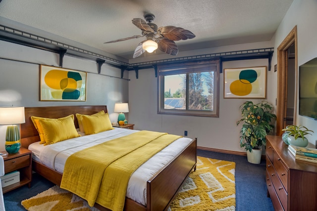 carpeted bedroom with ceiling fan and a textured ceiling