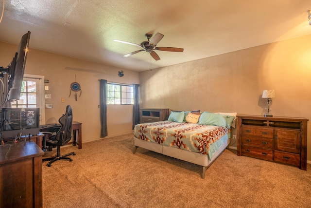 bedroom featuring a textured ceiling, ceiling fan, and light carpet