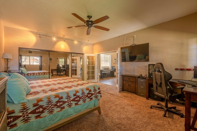 carpeted bedroom featuring ceiling fan and track lighting