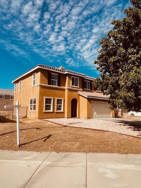 mediterranean / spanish-style home with a garage