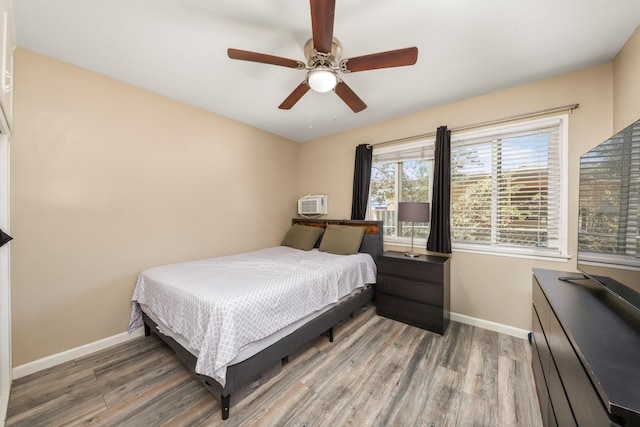 1524 Franklin Ave, Rosamond, CA 93560 - bedroom featuring ceiling fan, an AC wall unit, and wood-type flooring