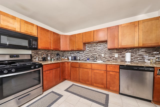 1524 Franklin Ave, Rosamond, CA 93560 - kitchen featuring appliances with stainless steel finishes, light tile patterned floors, sink, backsplash, and light stone counters