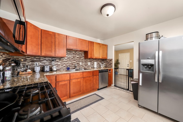 1524 Franklin Ave, Rosamond, CA 93560 - kitchen featuring light stone countertops, sink, backsplash, and black appliances