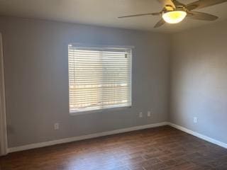 spare room featuring dark hardwood / wood-style floors and ceiling fan