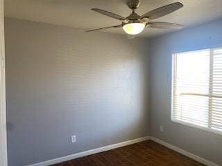 unfurnished room featuring a wealth of natural light and ceiling fan