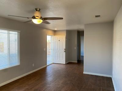 empty room with ceiling fan and dark wood-type flooring