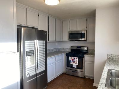 kitchen with sink, light stone counters, dark hardwood / wood-style flooring, white cabinets, and appliances with stainless steel finishes