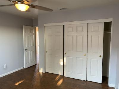 unfurnished bedroom featuring ceiling fan and dark wood-type flooring