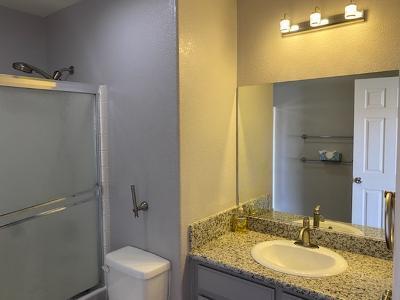 bathroom featuring vanity, an enclosed shower, and toilet