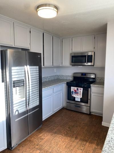 kitchen featuring white cabinets, dark hardwood / wood-style flooring, and stainless steel appliances