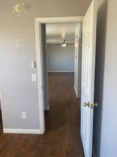 hall with dark wood-type flooring