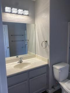 bathroom featuring vanity and toilet