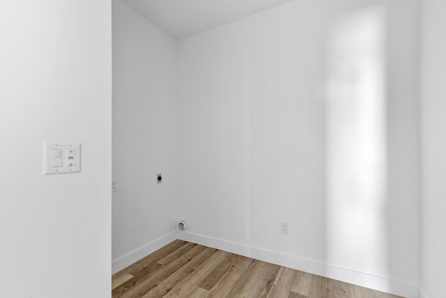 laundry area featuring electric dryer hookup and light hardwood / wood-style floors