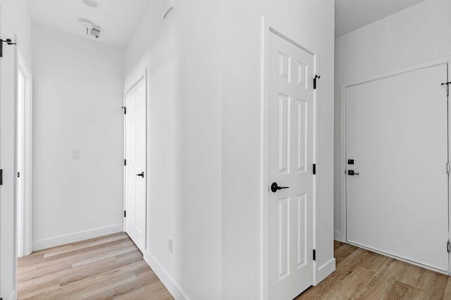 hall with light hardwood / wood-style floors