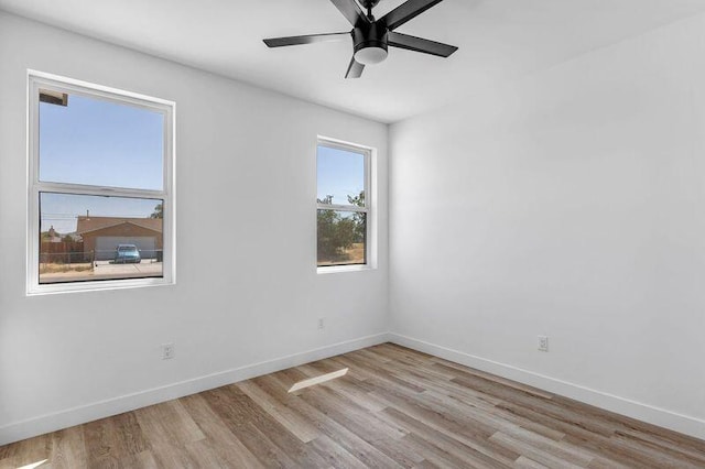 empty room featuring ceiling fan and light hardwood / wood-style flooring