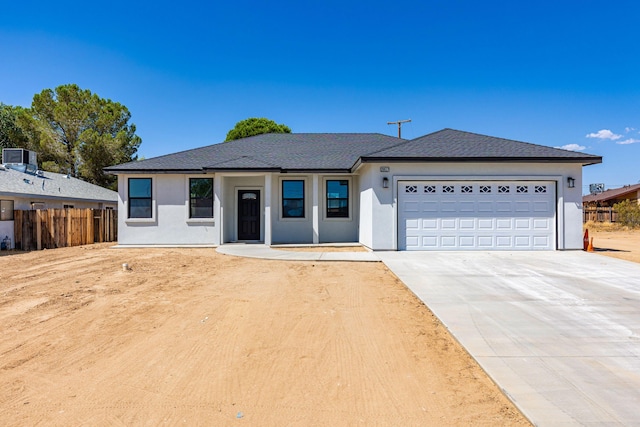 single story home with a garage and cooling unit