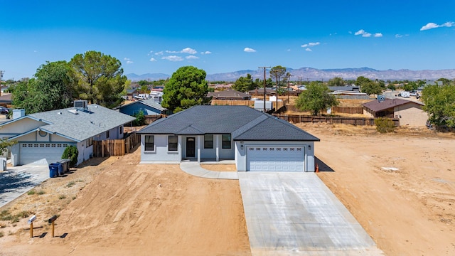 view of front of property with a mountain view and a garage