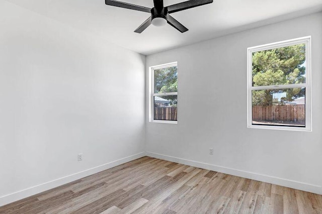 empty room with ceiling fan and light wood-type flooring