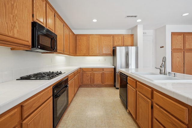 3024 Albret St, Lancaster, CA 93536 - kitchen featuring black appliances, a sink, tile countertops, recessed lighting, and brown cabinets