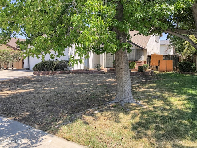 1132 Morven St, Lancaster, CA 93535 - view of grassy yard with concrete driveway and a garage