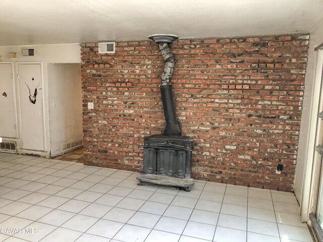 1132 Morven St, Lancaster, CA 93535 - unfurnished living room with brick wall and a wood stove