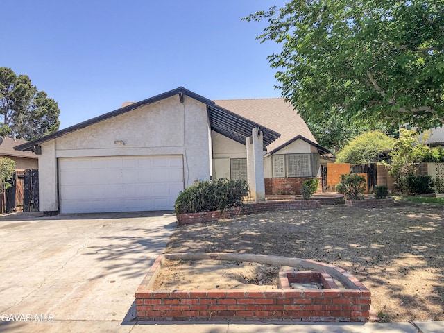 1132 Morven St, Lancaster, CA 93535 - view of front facade featuring driveway, an attached garage, and stucco siding