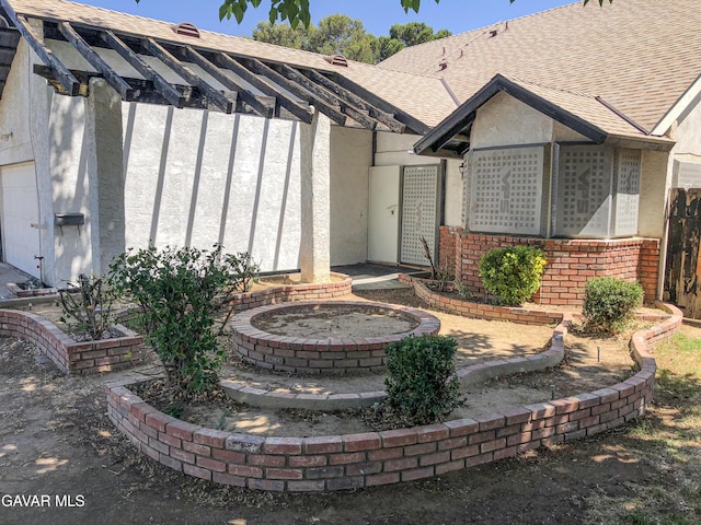 1132 Morven St, Lancaster, CA 93535 - entrance to property with stucco siding, a shingled roof, and brick siding